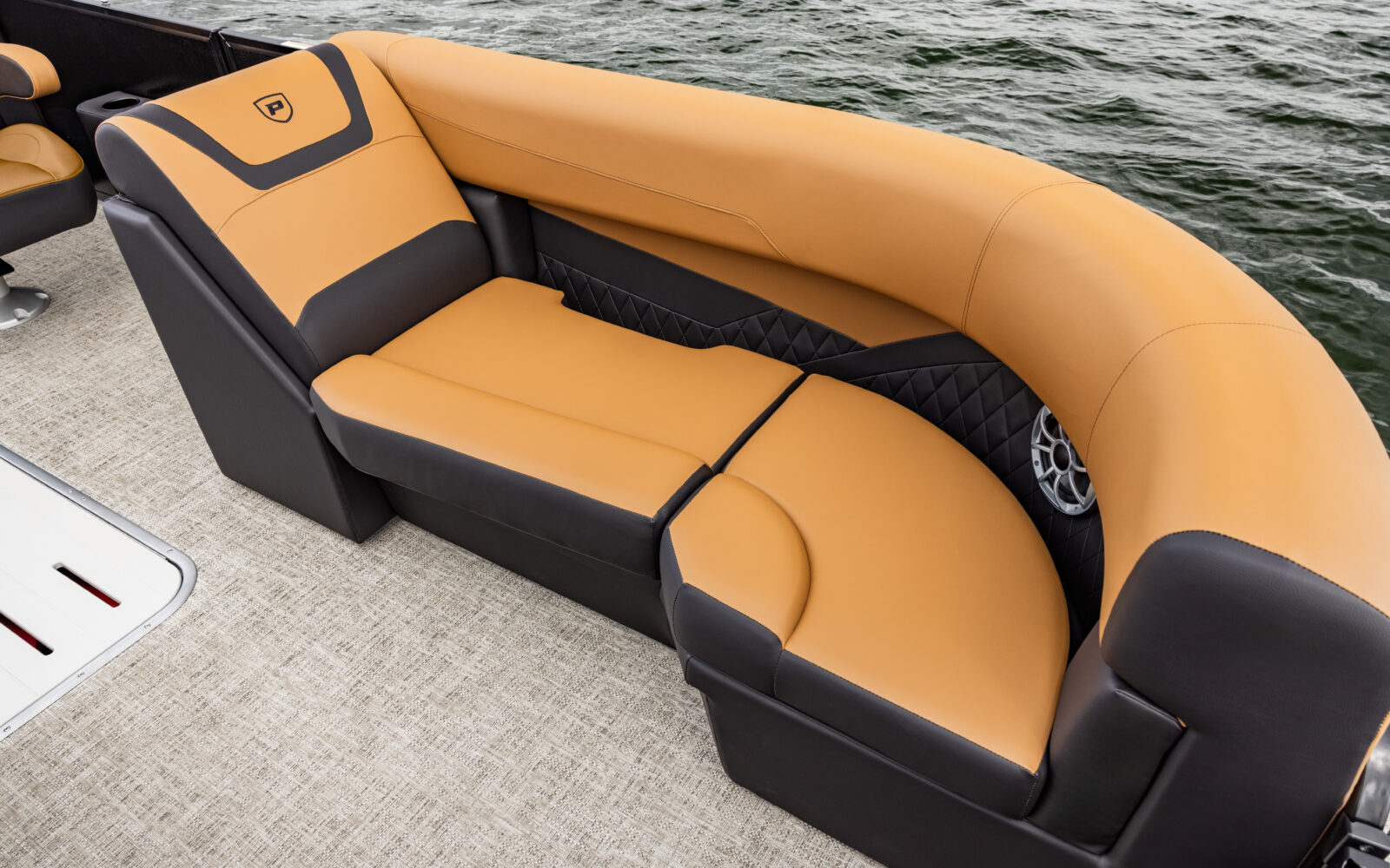 Premier Sunscape pontoon front couch seating with premium upholstery and integrated speaker.