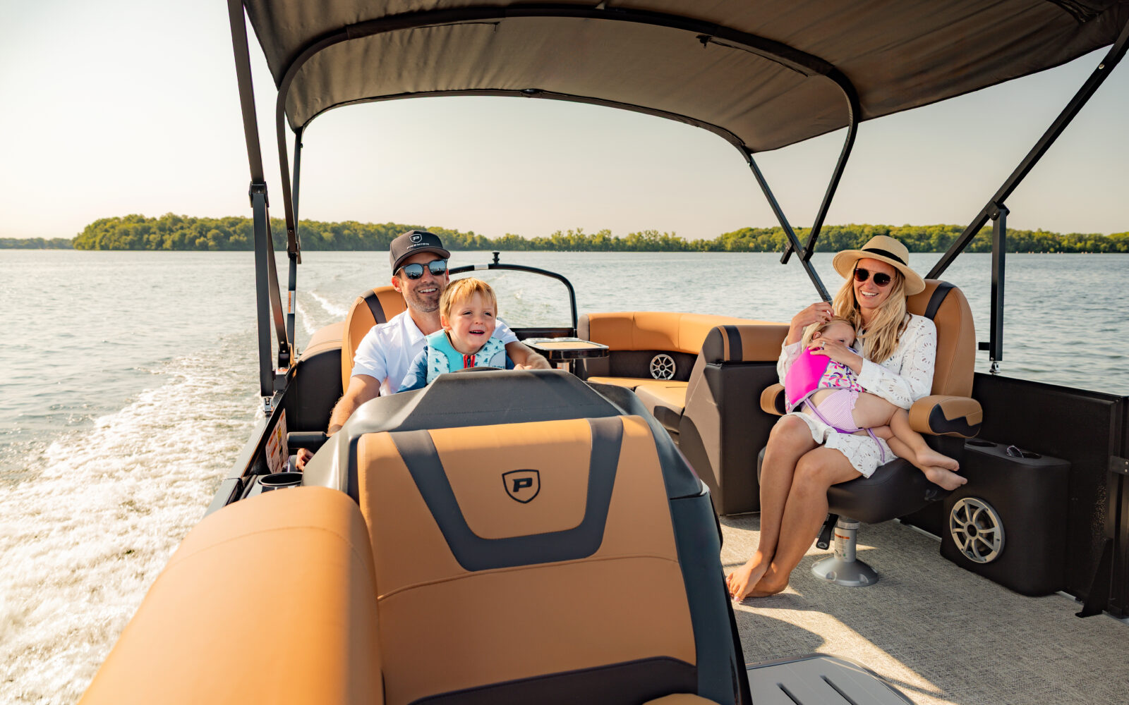 Family enjoying a day aboard a Premier Sunscape pontoon boat.