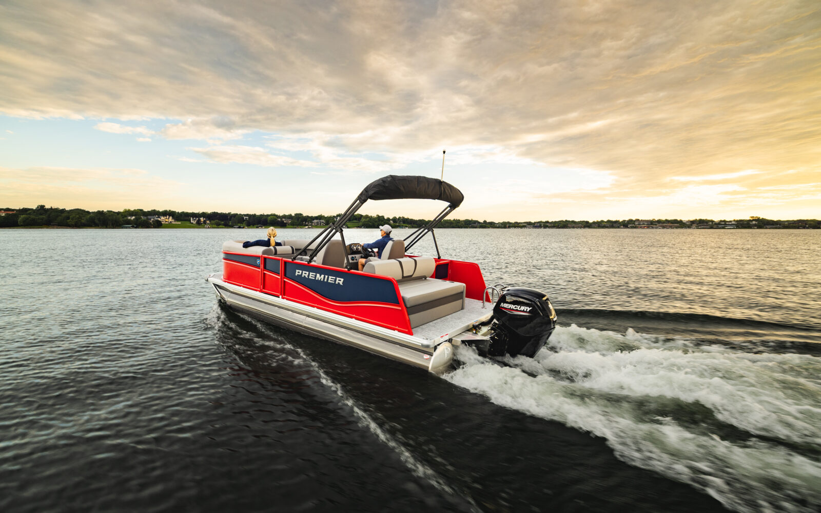 Premier Sunscape pontoon boat underway with Mercury outboard engine.