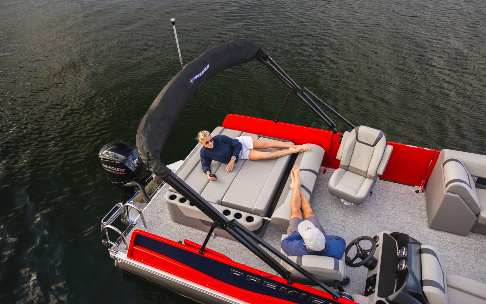 Premier Sunscape pontoon rear lounge with Mercury outboard.
