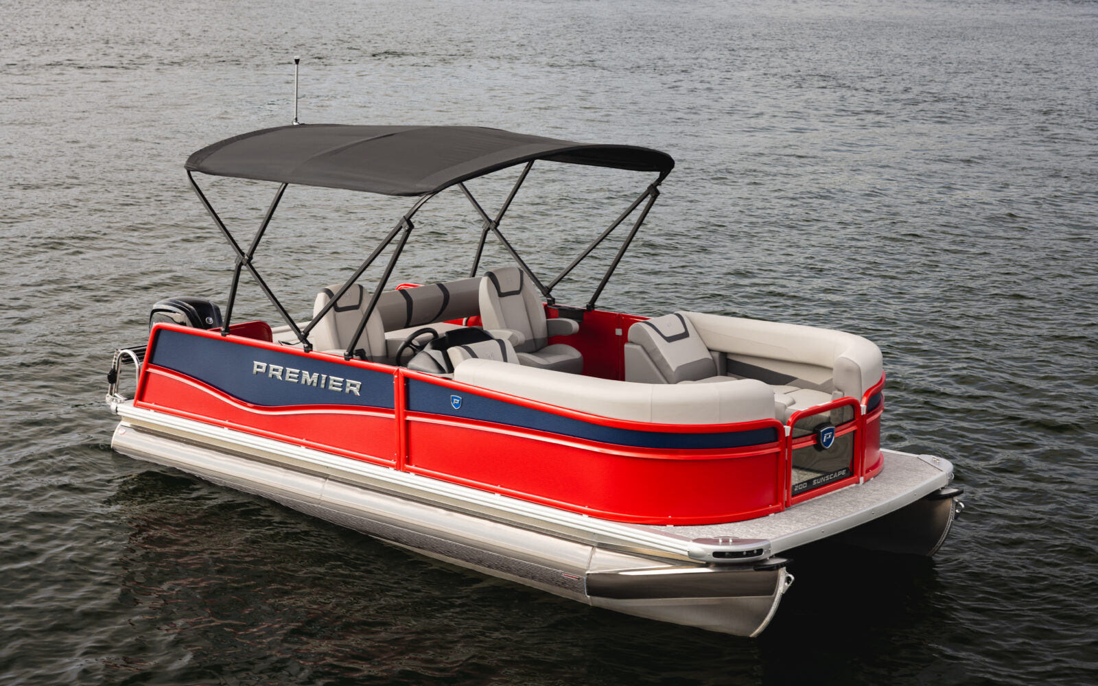 Red Premier Sunscape pontoon boat with bimini top on the water.