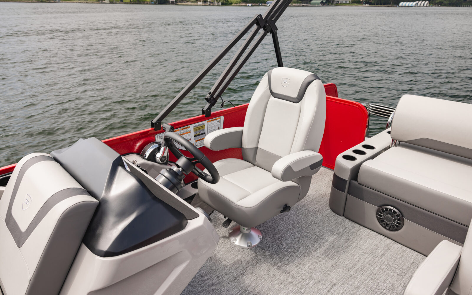 Premier Sunscape pontoon helm with captain's chair, steering console, and premium seating.
